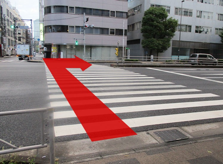 Cross the traffic light and proceed to the right.