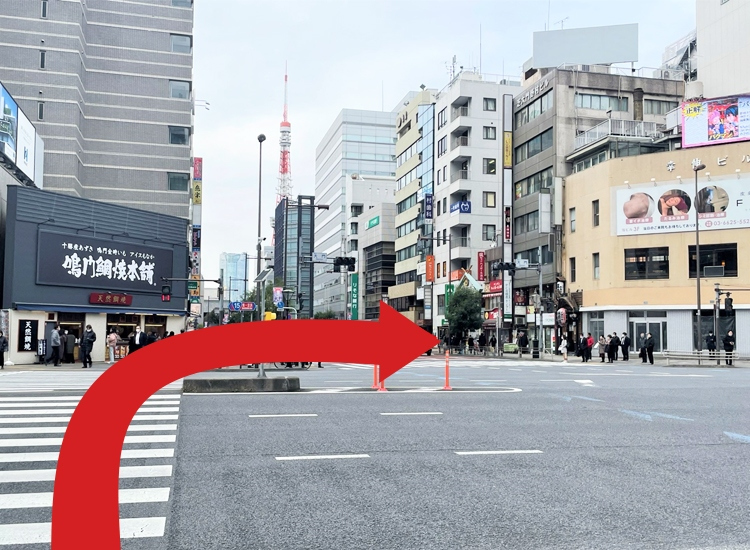 Walk for about 2 minutes until you get to the intersection of Daimon. Cross the streets towards "Koshin Building (幸伸ビル)" located diagonally across from you.