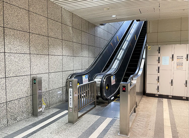 Go up the escalator.