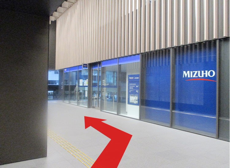 Enter through the passageway next to Mizuho Bank.