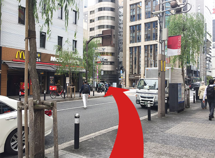 Cross the pedestrian crossing and proceed to the front of McDonald's.