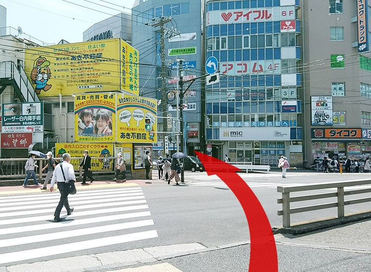 Cross the pedestrian crossing.