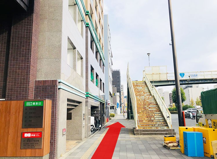 Cross the pedestrian crossing and keep going straight.
