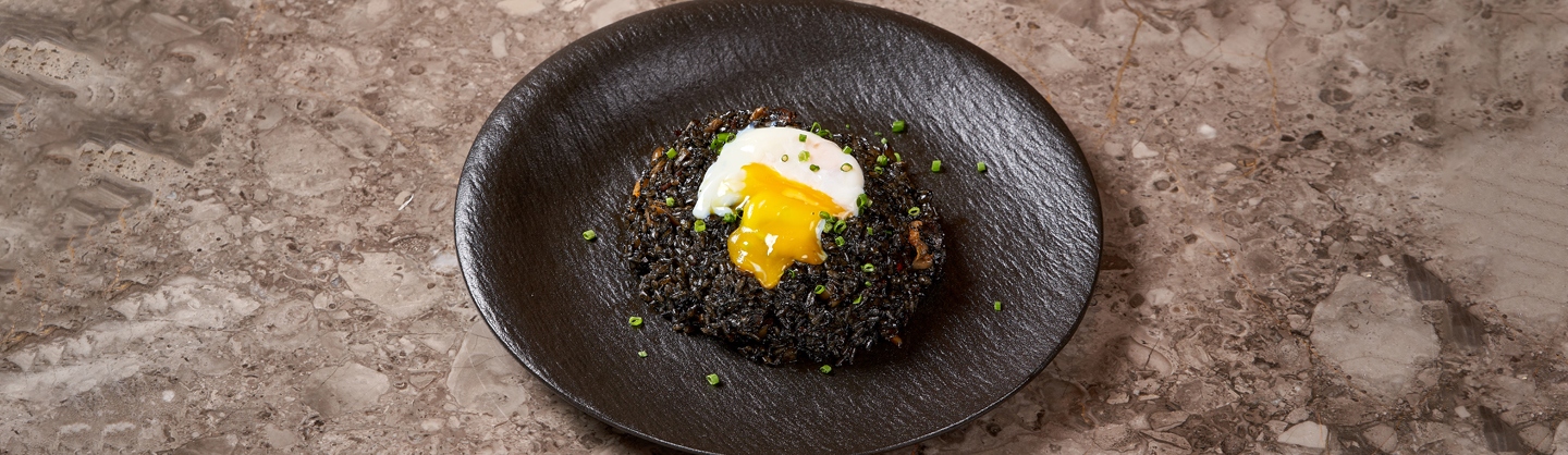 Squid Ink Kimchi Fried Rice topped with Poached Egg